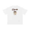 A white short-sleeve t-shirt with a graphic on the chest featuring the text 'Cafecito' and a cute cartoon coffee cup character, displayed on a clean white background.