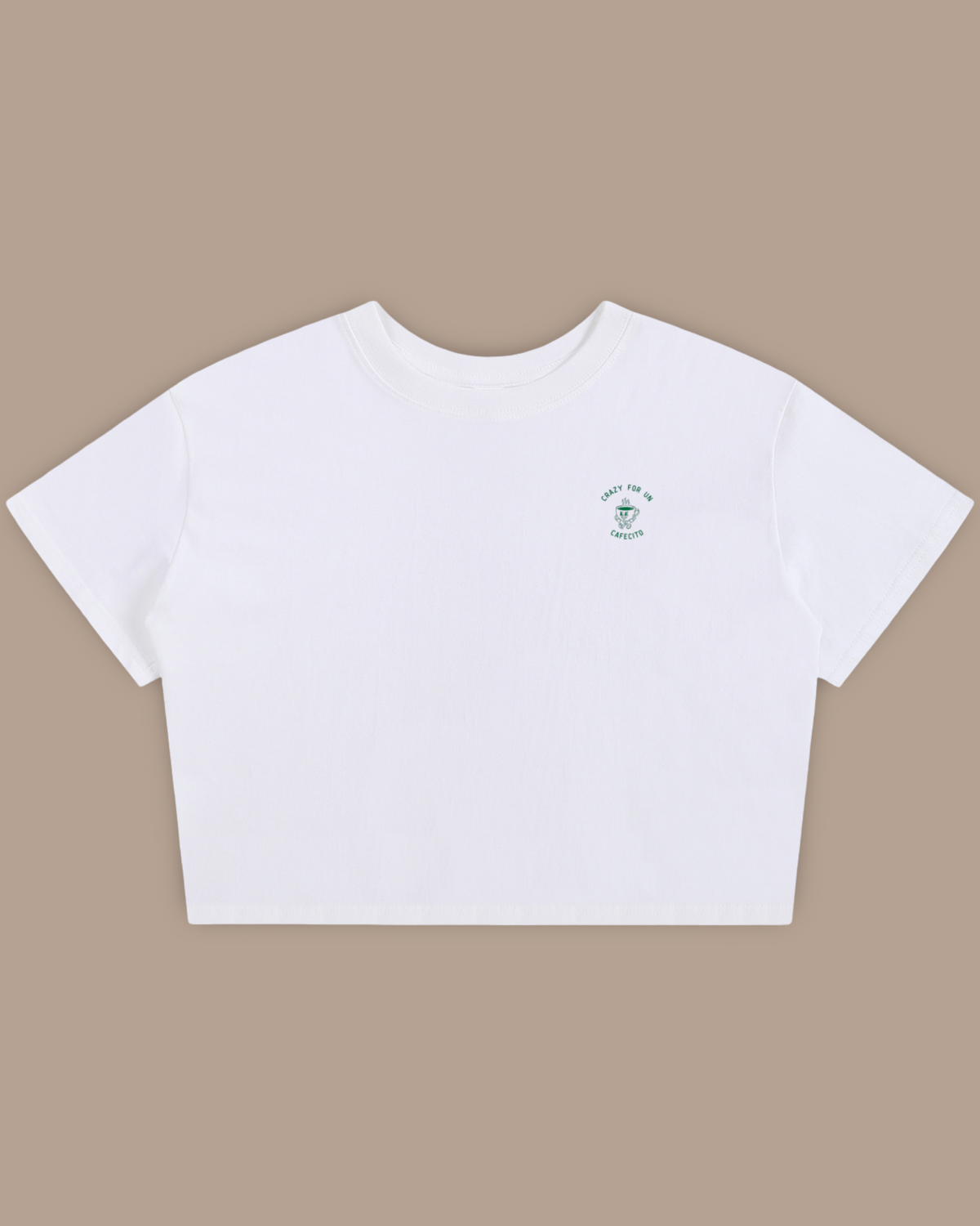 A womens white short-sleeve crop top featuring a green line art graphic of a cafecito coffee cup with the words Crazy for un Cafecito. Crazy for Coffee.