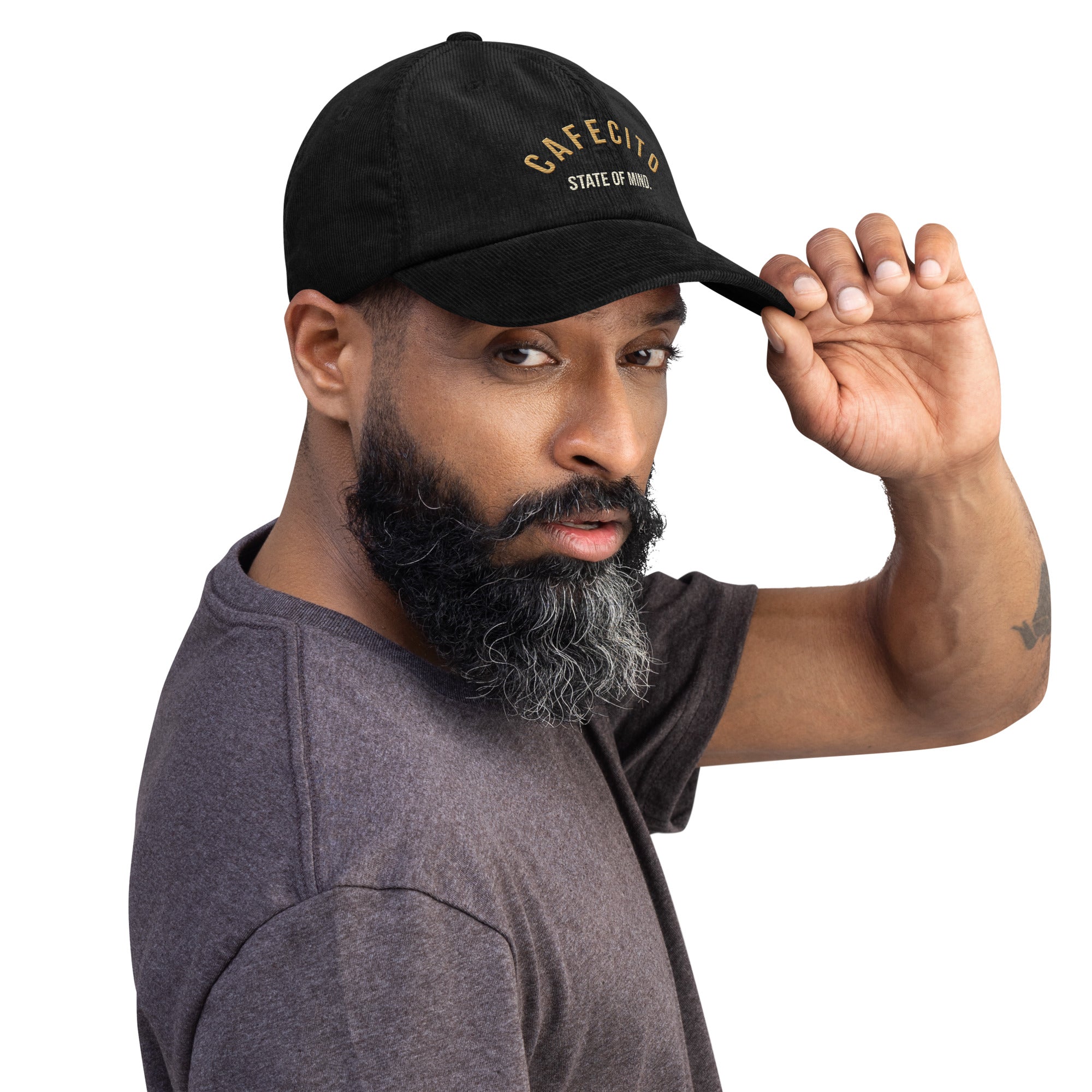 Man wearing a black coffee shop cap with state of mind txt