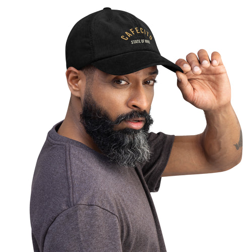 Man wearing a black coffee shop cap with state of mind txt