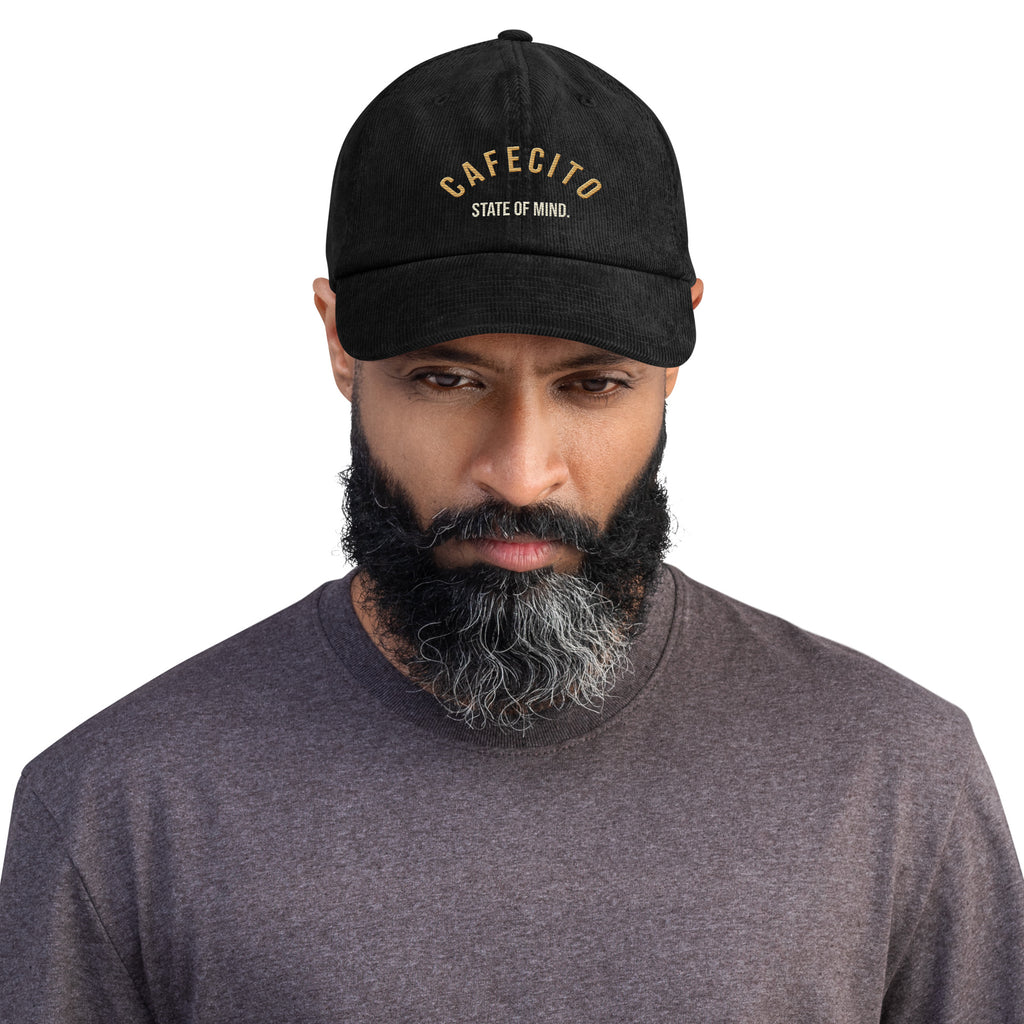 man wearing a coffee hat cafecito state of mind