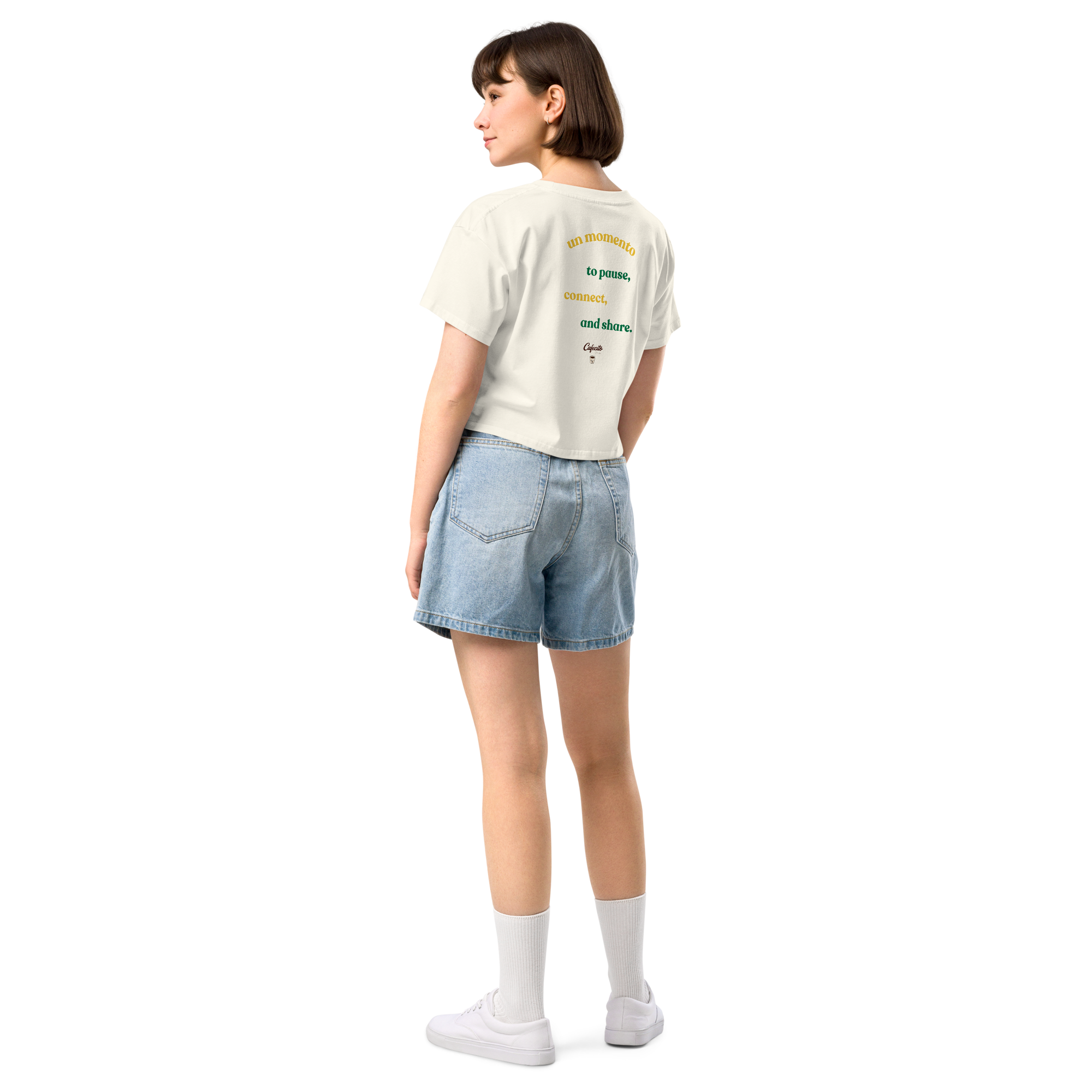 Person wearing a white coffee t-shirt with cafecito text and denim shorts 